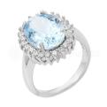 Кольцо из серебра с голубым топазом и фианитами родированное