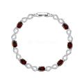 Браслет из серебра с гранатом и кубическим цирконием родированный